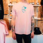 Man wearing pink love wins tee.